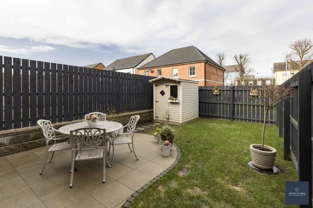 The fully enclosed rear garden with gated access to front. The garden has been laid in lawn with a paved patio area and brick pavor boundary. There is a paved area for a garden shed with power supply available and there is an outside tap and lighting.