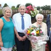 Mayor of Causeway Coast and Glens, Councillor Steven Callaghan presents Sammy and Annie McGregor with a gift to mark their diamond wedding anniversary. Also pictured is daughter Rhonda Thompson. Credit Causeway Coast and Glens Borough Council