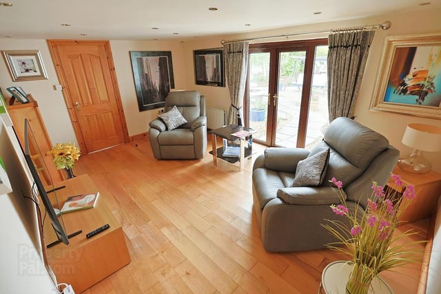 The lovely family room (11‘1“ x 16‘1“) has a wooden floor, feature spotlights and double doors leading to the courtyard.