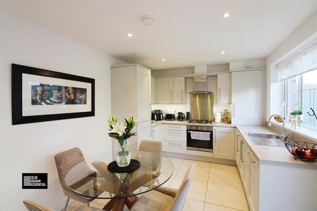 Modern fitted kitchen with range of high and low level storage units.