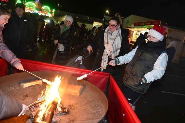 Ronan Diamond getting toasty by the fire pit at the Crumlin Light Switch On