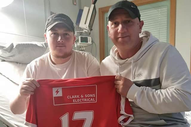 Glebe Rangers fan Kofi Blair and his father Stevie with one of the club's jerseys