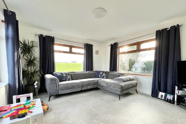 The family room, located to the side of the property, is fitted with feature wall panelling, TV point and tiled floor and is open plan through to the kitchen / dining area.