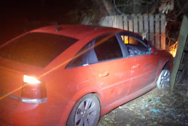 The red Vauxhall Vectra collided with the fence of a house. Photo release by PSNI