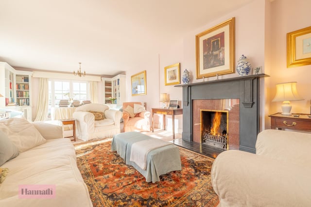 The drawing room has an antique fireplace with feature surround, tiled heath and cast iron inset. There are matching fitted mahogany corner book cases and cupboards and double patio doors opening onto a walled courtyard.