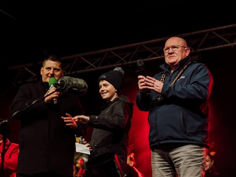 The Mayor, Cllr Neil Kelly and Stuart Robinson invite competition winner Callum Longstaff onto the stage.