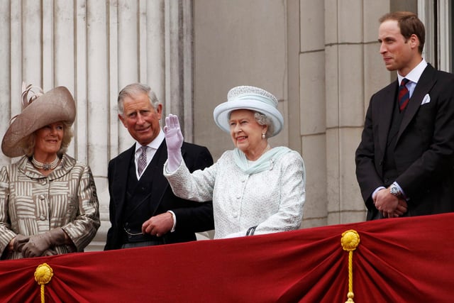Queen Elizabeth II waves to the crowds from the balcony of Buckingham Palace as Camilla, Duchess of Cornwall, Prince Charles and Prince William look on during the Diamond Jubilee celebrations in central London.