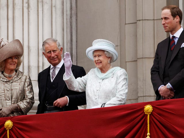 Queen Elizabeth II waves to the crowds from the balcony of Buckingham Palace as Camilla, Duchess of Cornwall, Prince Charles and Prince William look on during the Diamond Jubilee celebrations in central London.