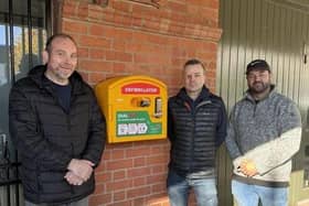 ​Alderman Paul Rankin, fundraiser Peter Branker and Jamie McCutcheon, Dromore Chamber of Commerce, at the site of the new defibrillator.