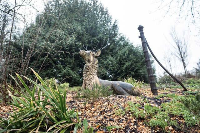 A large stone stag has been placed beside a section of original metal fencing to symbolise that the estate once had a deer park.