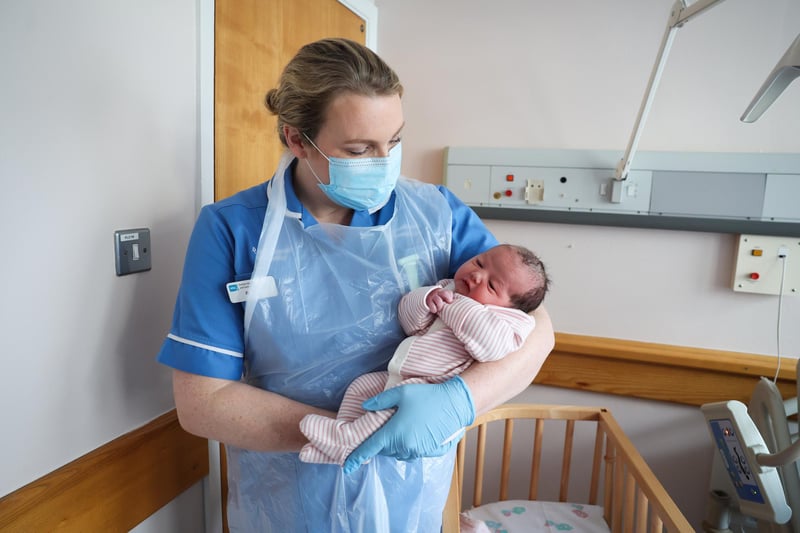 Midwife Grainne Holland pictured with the daughter of Stacey Rooney who was born at 3.04am on Christmas Day and weighed 9lbs at the Royal Victoria Hospital, Belfast. Picture: Kelvin Boyes / Press Eye.