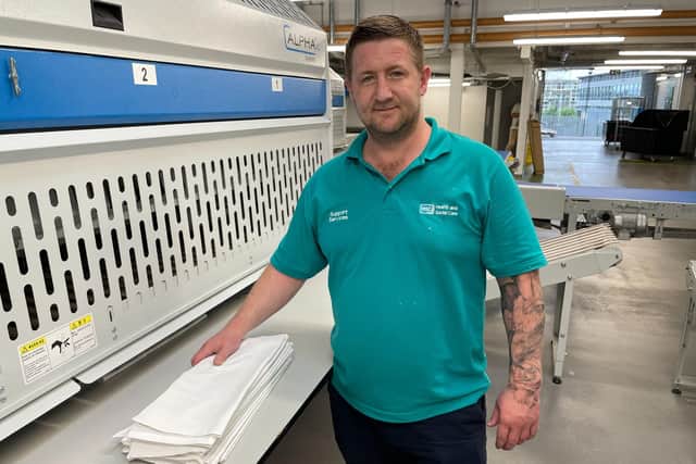 Andrew Savage, Laundry Supervisor at the folding machine. Pic credit: SEHSCT