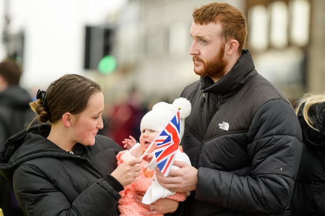 One of the younger members of the crowd waits for a glimpse of the royal couple in Carrickfergus.