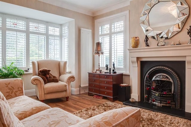 Lounge with feature cast iron horseshoe-style fireplace.