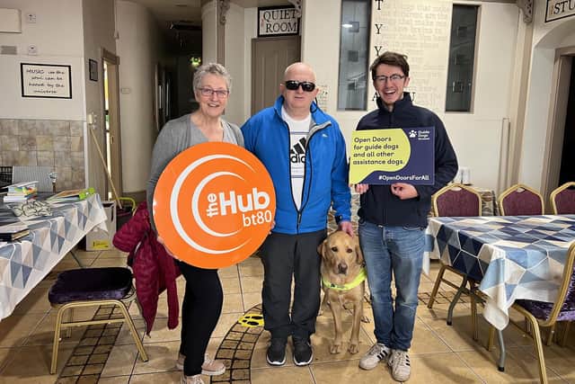 Pictured, from left, are Carol from The Hub BT80, Gary Morton, Buster and Mark Quinn, Marcomms Manager from Guide Dogs NI