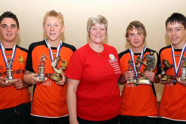 Under 15 trophy winners with Tesco Community Champion Anne Ritchie at a Barn Utd Youth presentation in the Knockagh Lodge in 2010