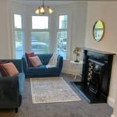 Open plan lounge with feature original Victorian fireplace.