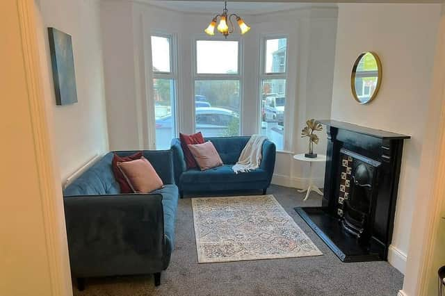 Open plan lounge with feature original Victorian fireplace.