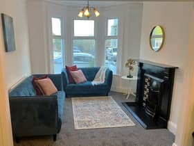 Open plan lounge with feature original Victorian fireplace.