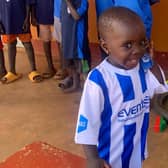 One of the children from Dikka wearing a Coelraine top.