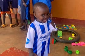 One of the children from Dikka wearing a Coelraine top.