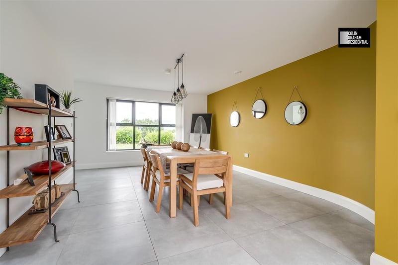 Dining room with dual aspect windows and tiled floor.