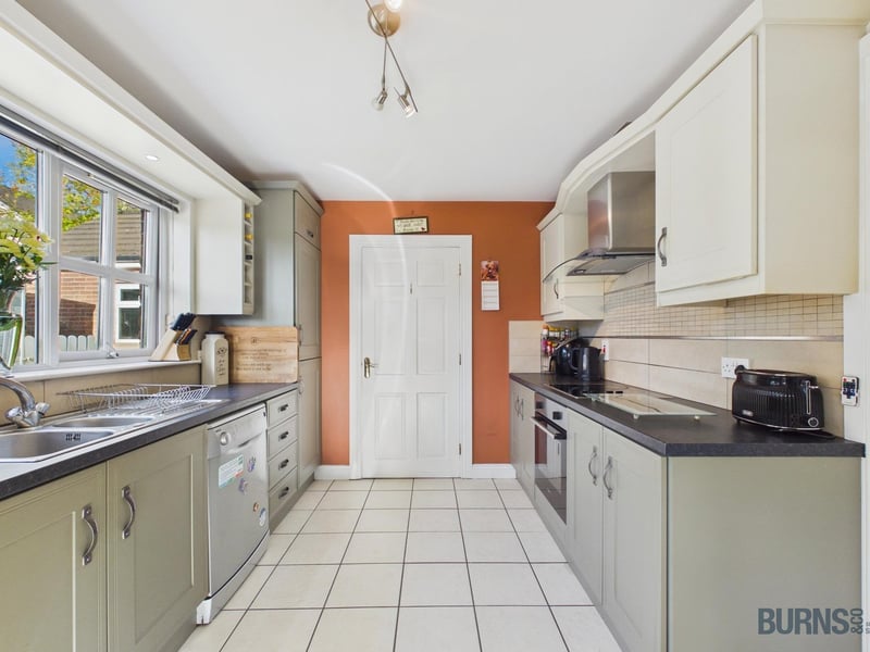 The well-equipped kitchen enjoys direct access to the rear garden.