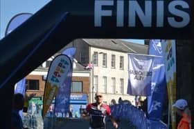Crossing the finishing line at a previous Carrickfergus Castle Triathlon. The 2023 event has attracted over 300 entries. Photo by; Gary Davison