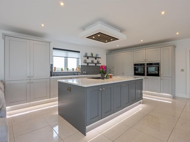 Luxury fitted kitchen with comprehensive range of high and low level storage units.