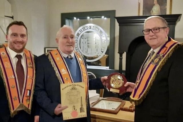 Brother William McCaw is presented with 60 year gifts by Bro Robert McIroy as Bro Wesley Craig looks on