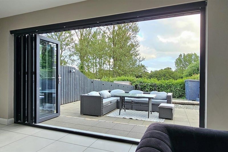 The living/dining area has double glazed bi-fold doors opening onto a rear sun patio.