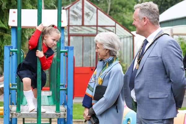 The Duchess of Gloucester learning about the Edenvilla Secret Garden from a young member of the community.
