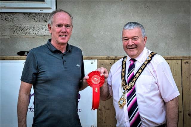 Causeway RDA representative John Wisener presents the Mayor Cllr Ivor Wallace with a rosette
