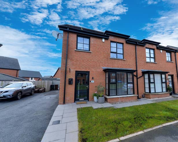 The property has an attractive red brick façade and ample parking space.