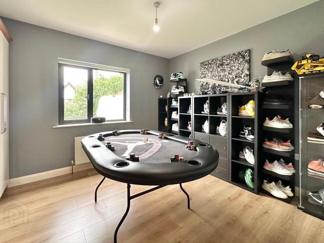 Bedroom with laminate wood floor, built in bedroom furniture. Currently used as games room.