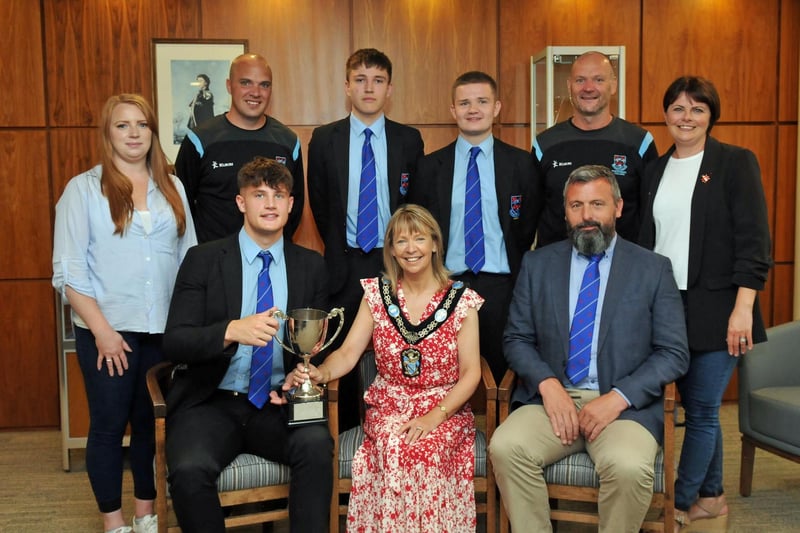 Lord Mayor of Armagh City, Banbridge and Craigavon, Councillor Margaret Tinsley celebrates Portadown College winning the Schools Rugby Trophy with,  First XV captain, Jamie, Head Coach Mr Alistair Toal and standing, pupils Daniel and Tom, coaches Mr Stephen McDowell, Mr Andrew Symington, Councillor Kate Evans and Councillor Julie Flaherty.