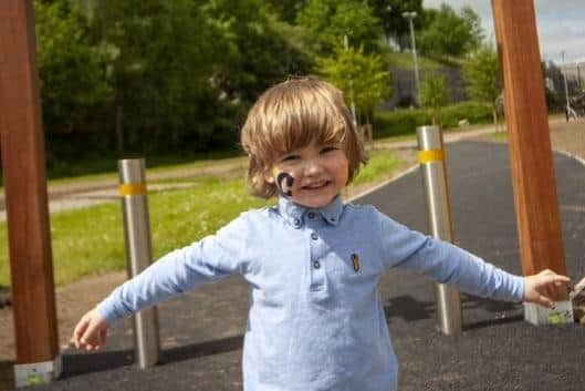 Four-year-old Caiden is all smiles ahead of this year’s Coalisland Summer bash as it returns to a new venue at the Shared Space, Lineside in Coalisland on Sunday May 28.