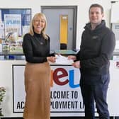 Jackie Reid, head of business at Access Employment Limited is presented with a cheque by Martin McMullan,  site director from Terumo. Photo: AEL