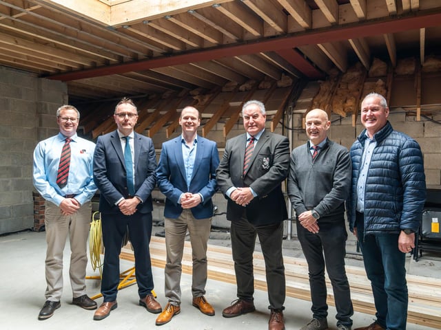Minister Lyons meets with representatives from Rainey Rugby Football Club to view ongoing work facilitated by the Northern Ireland Community Infrastructure Fund.
