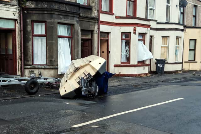 An overturned boat and damaged properties in Ballymena. Picture: Pacemaker