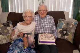 Platinum partners...Muriel and George Quinn are all smiles as they celebrate their 70th wedding anniversary with a card from the King and Queen and a special anniversary cake at a surprise party organised by their family on Saturday. PT10-218. Picture: Tony Hendron