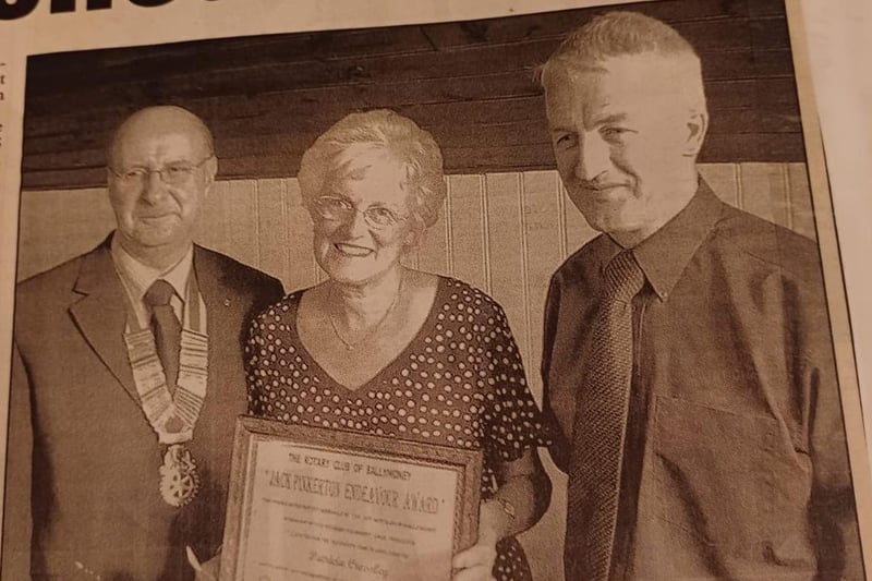 Pat Crossley displaying the 2005 Jack Pinkerton Endeavour Award along with Ballymoney Rotary Club President John Laverty and Rotary Foundation Convenor Jimmy Dunlop