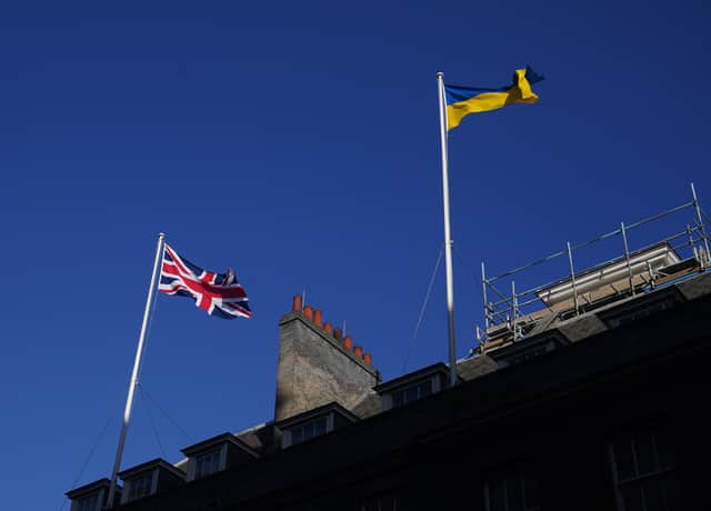 File photo dated 25/02/22 of The Ukrainian flag being flown above 10 Downing Street in London, as the UK's visa schemes for Ukrainian refugees are "lacking in clarity, resourcing and accountability" and are heightening the risk of trafficking and exploitation, according to a report.