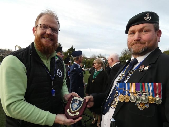 Paul Castle of Larne Royal British Legion presents a plaque to the band.