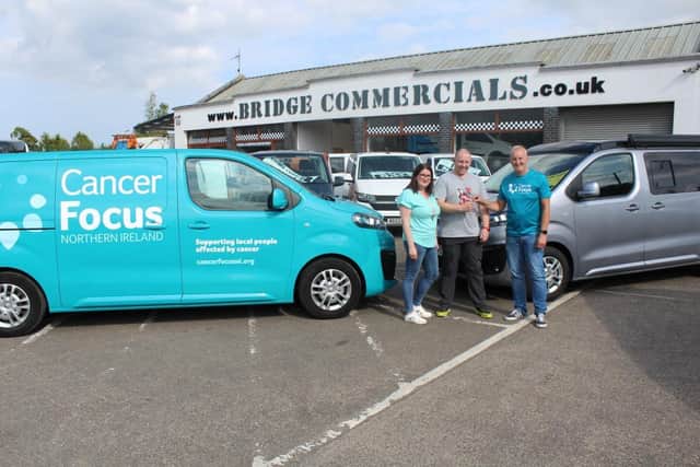 Paul Thompson hands over the keys to the campervan to Andy and Laura Coburn. The profit from the sale will be donated to charity. Pic credit: Paul Thompson