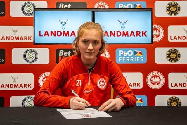 Kate Smith puts pen to paper for a pro deal at Larne. Submitted