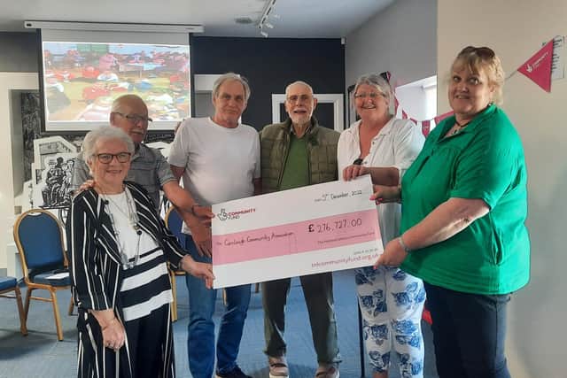Pictured, from left to right, at the Carnlough Community Association funding presentation are: Patricia McConnell, chairperson; Dennis Corrigan, committee member; Greg White, member, Carnlough Bowling Club; Keith Cruttenden, treasurer; Geraldine Moorcroft, member, Arts Project and Mary Elizabeth, member, Croft Community Garden and Luncheon Club.