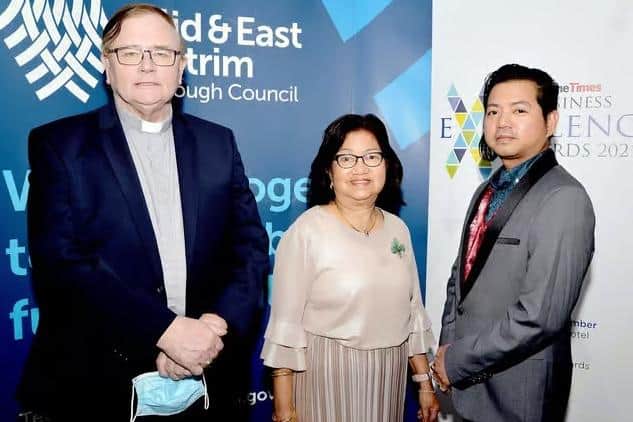 Pat Buckley and Eddie Yanga pictured with Paz Yanga at the Larne Business Excellence Awards in September 2021. Picture: Tony Hendron