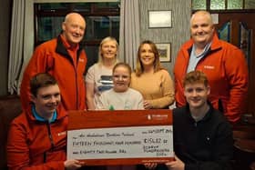 Air Ambulance NI volunteer Alan Morrow receiving a cheque for £15,482.33 from the Crawford family, alongside Gillian Greer from The Park Inn and Mackenzie Gordon.