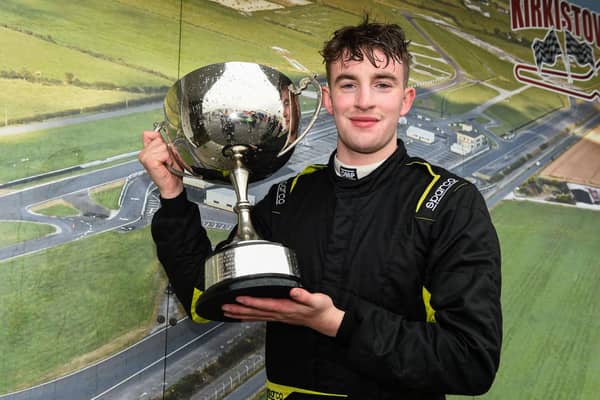 Ronan Doherty holds up the Emerson Fittipaldi trophy after winning the Formula Vee race. Kirkistown Racing Circuit. Picture: Barry Cregg.